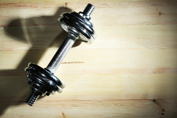 Dumbbell on wooden floor background