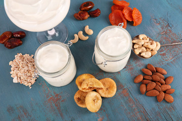Healthy breakfast with dried fruits and nuts on color wooden background