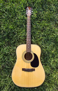 Acoustic Guitar on the grass isolated