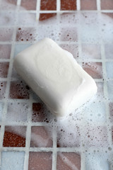 Soap with bubble on mosaic tiles background