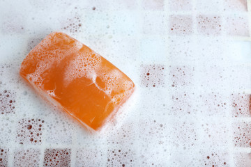 Soap with bubble on mosaic tiles background