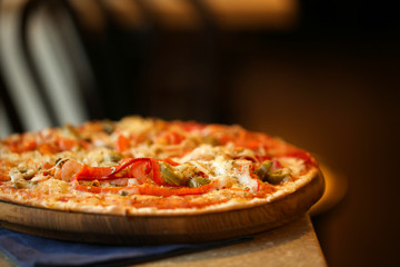Delicious pizza on table in cafe