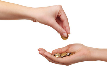 Female hand putting coin into another hand isolated on white