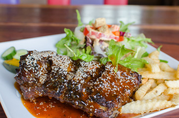 rib steak with vegetables on white plate