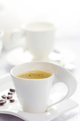 Cup of coffee on white wooden background