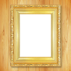 Antique gold frame on wooden wall;. Empty picture frame on woode