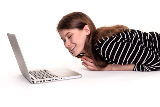 Young Happy Woman lying on floor with Laptop Stock Image
