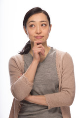 Young Asian woman thinking pose in studio