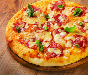 Fresh homemade salami pizza on  wooden  board