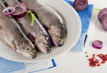 Rainbow trouts on  white plate.