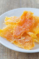 Piece of Dehydrated mango on white ceramic dish