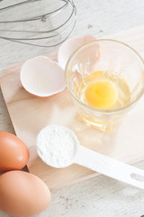 ingredients and tools to make a cake, eggs, bakery cups