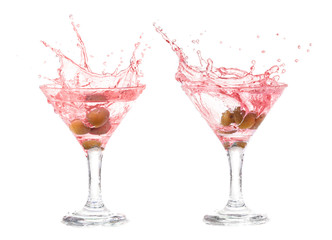 Splash from olive in a glass of cocktail.
