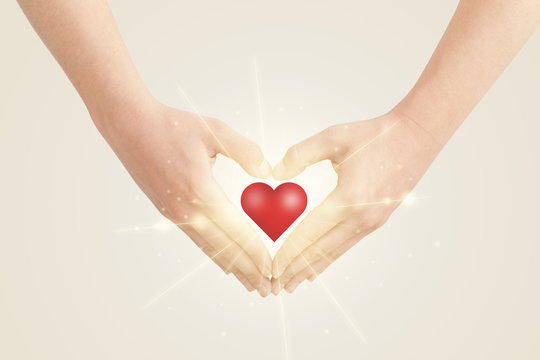 Hands creating a form with shining heart