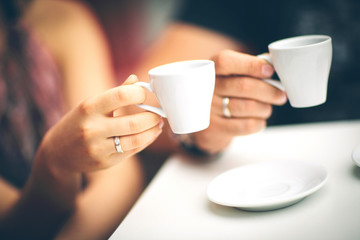 two hands and cup of coffee