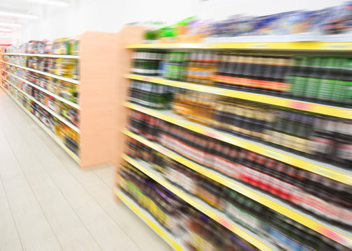 Shelves with beverages bottles in grocery food store supermarket