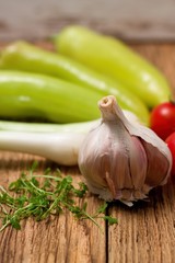 Garlic and cress shoots in front of other vegetable