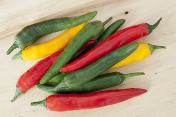 Heap of bright red, yellow and green chili peppers