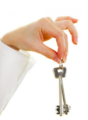 House keys in the female hand on a white background