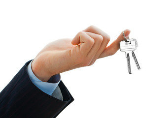 House keys in the female hand on a white background