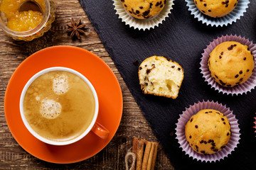 muffins with chocolate on a stone tray served with a cup of coff