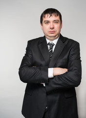 Fashion young businessman black suit  studio