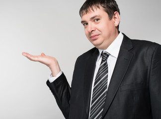 businessman holding something in his hand