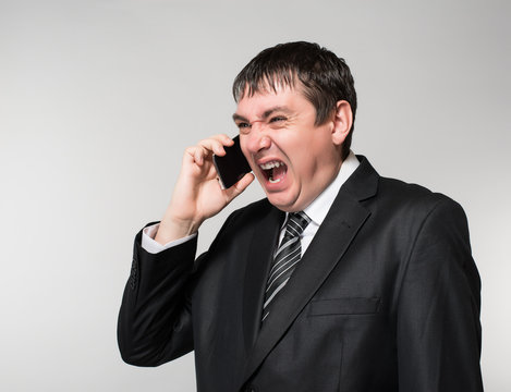 young businessman emotionally speaks on the phone