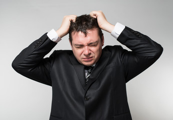 businessman in depression with hands on his head