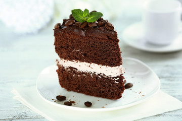 Delicious chocolate cake on table on light background