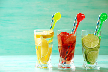 Cocktails with fresh strawberries and lemons on wooden background