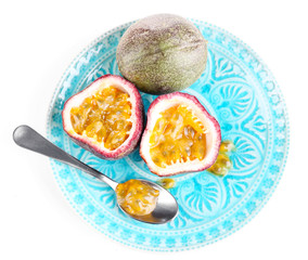 Passion fruit on plate isolated on white