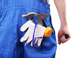 Man in coveralls with tools in his pocket isolated on white