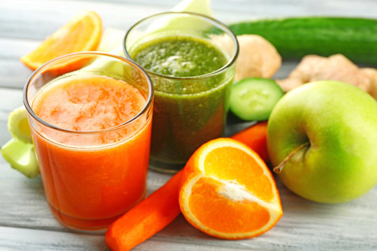 Assortment of healthy fresh juices on wooden table background