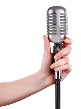 Retro microphone in female hand isolated on white