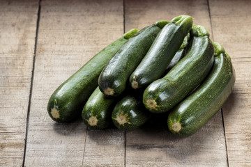 Green zucchini on wooden table