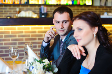 Young attractive couple enjoying sitting together in a restauran