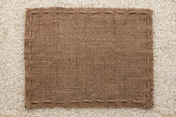 Frame made of burlap with the line lies on  rice  grains