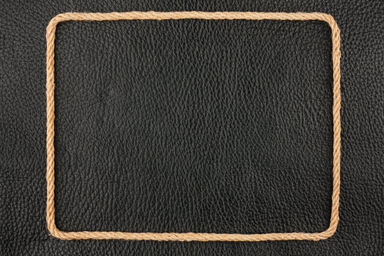 Frame of rope, lies on a background of a black natural leather