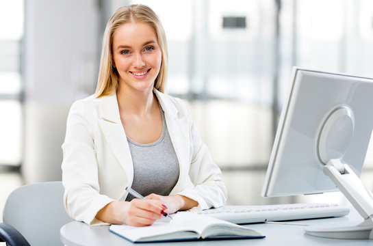 Young business woman using computer at office