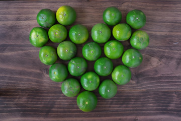 green orange on the table, heart shape