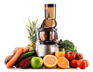 Slow juicer with organic fruits and vegetables isolated on white