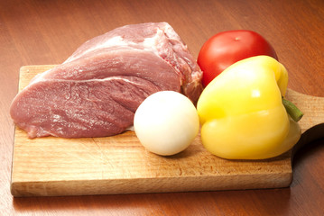 Raw fresh meat on board with condiments on white background