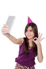 Naklejka premium Sweet Asian party girl taking selfie, isolated on white