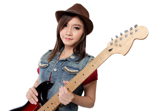 Beautiful punk rock girl with her guitar, on white background