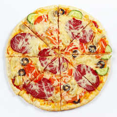 Great flavorful pizza sliced into chunks on a white background