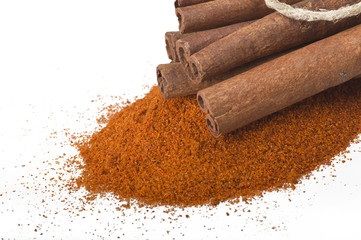cinnamon sticks with powder on the white background