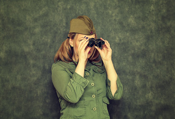 Girl in garrison cap during the Second World War, binoculars