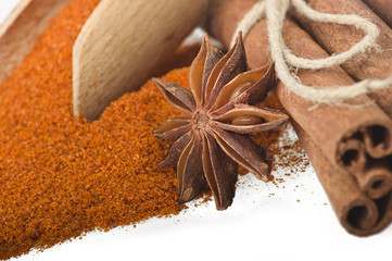 cinnamon sticks with powder on the white background
