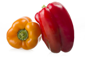 colored peppers close up over white background